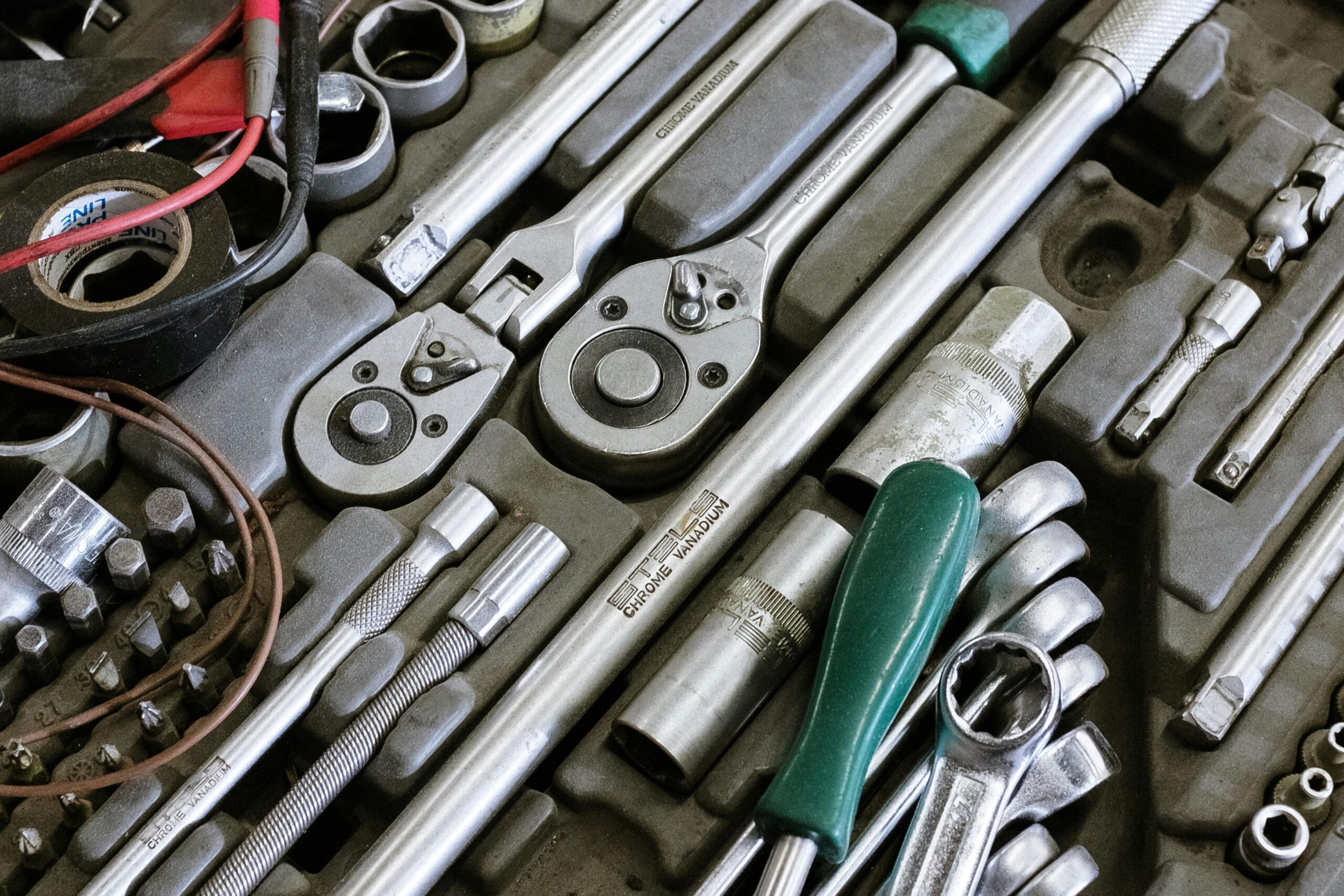 Detailed photo of various mechanic tools organized in a workshop setting. Perfect for repair themes.